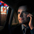 Man in the back of cab talking on phone