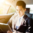 Businessman working in the back of taxi